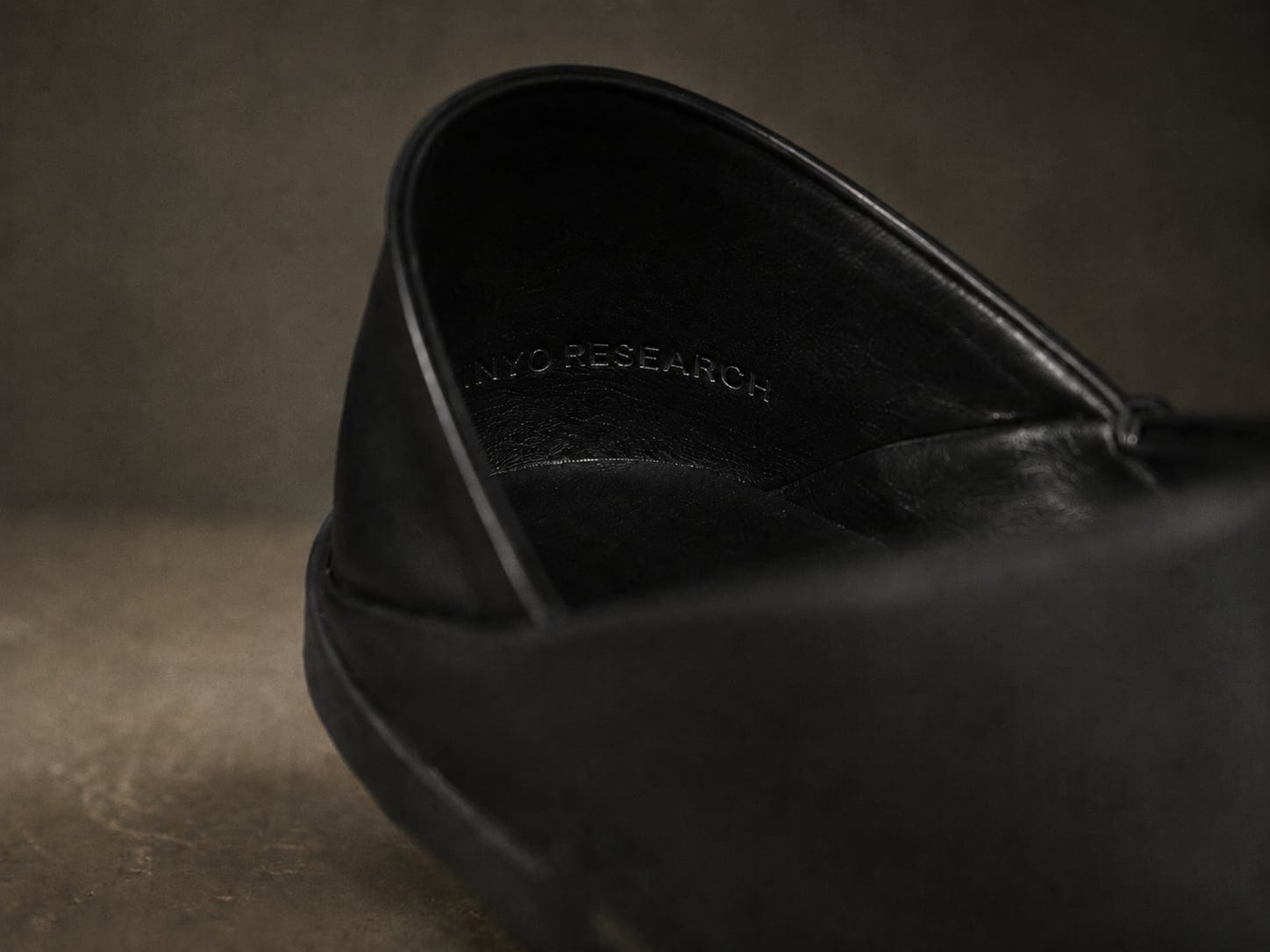 Interior topline of the leather mule, embossed INYO RESEARCH.