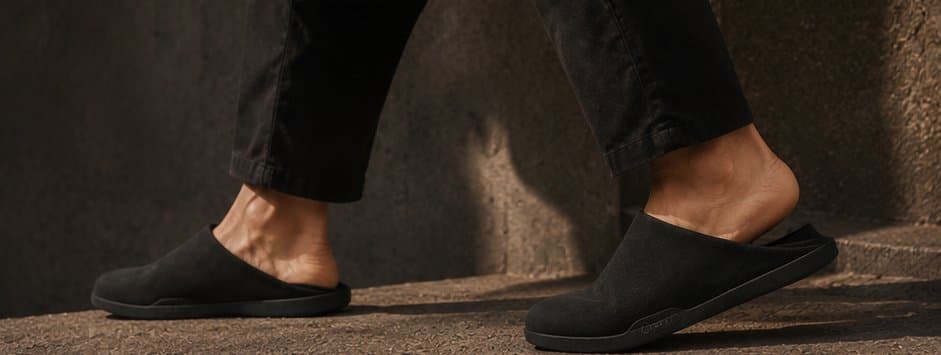 Walking down warm stone steps in black mules.