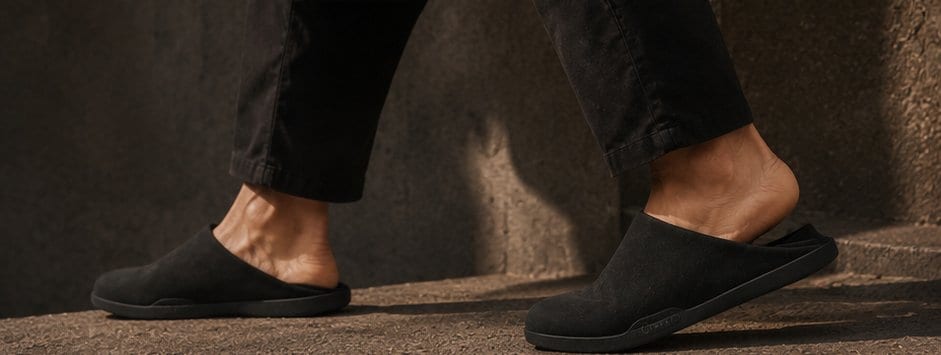 Walking down warm stone steps in black mules.