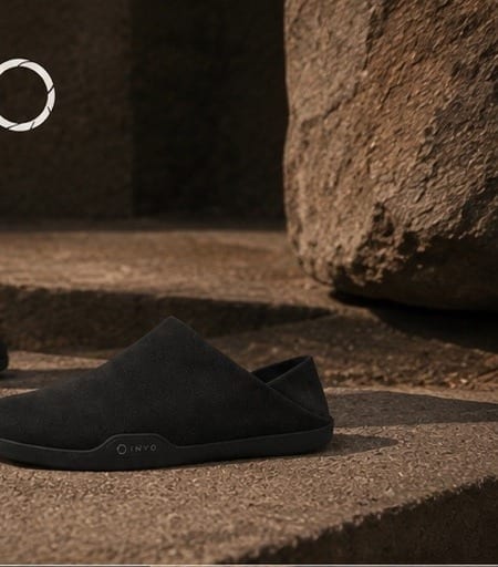A heel hovering over the worn edge of a stone step.